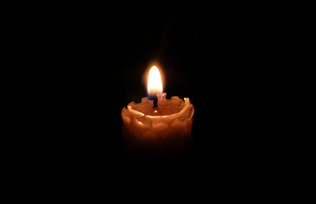 memorial candle glowing softly representing reflection and preplanning support from funeral homes Eastampton Township NJ.